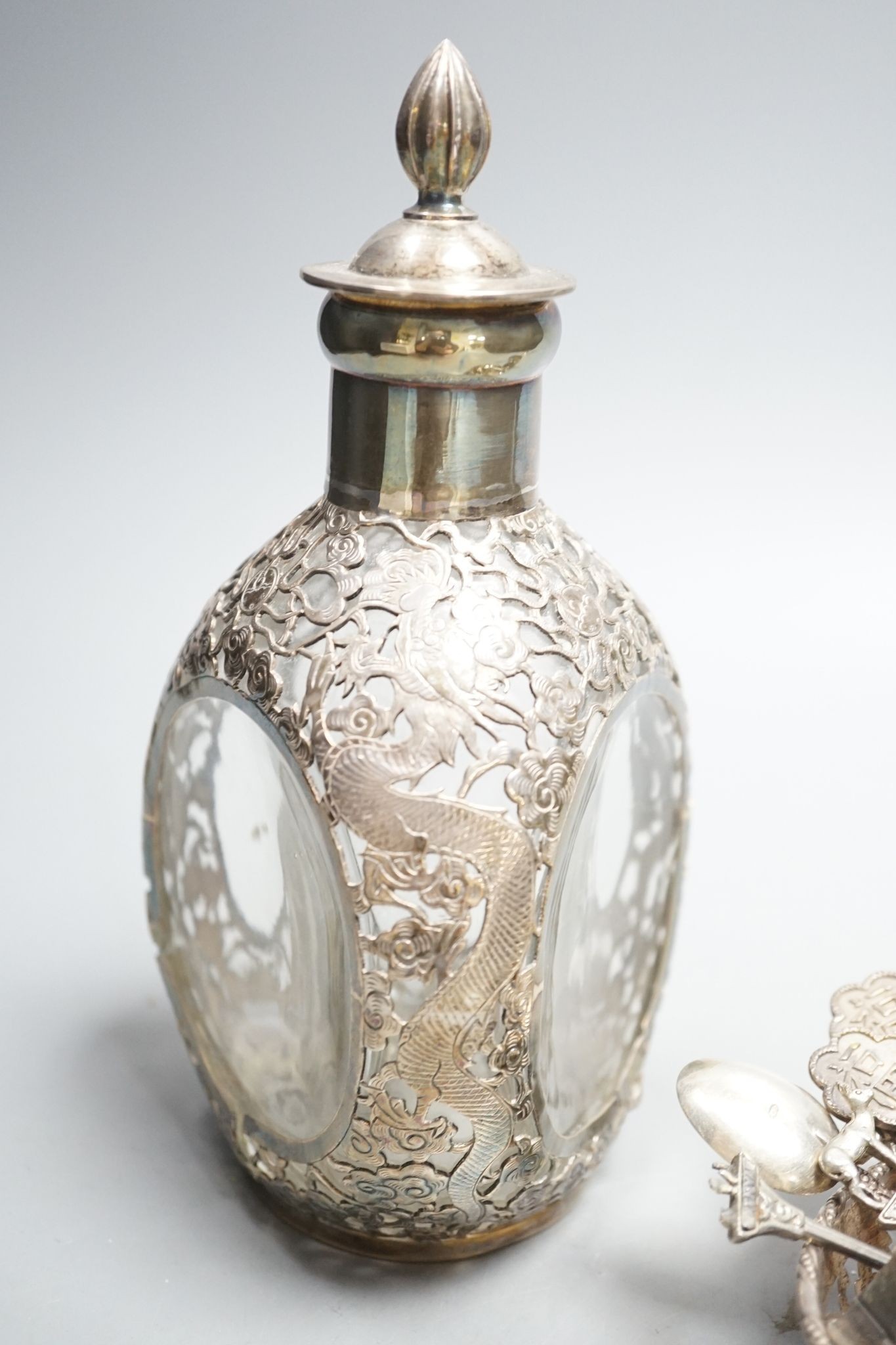A Chinese white metal overlaid glass dimpled decanter and stopper, 19.1cm, a 900 small vase, a pierced silver bowl and a group of assorted Chinese and other white metal spoons.